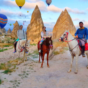 Traveler enjoying a horseback riding tour in Cappadocia’s scenic landscapes.