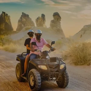 Adventurers on an ATV tour enjoying the breathtaking sunset view over Cappadocia