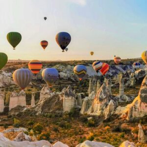 Colorful hot air balloons drifting over Cappadocia’s valleys