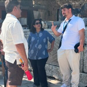 Travelers walk the ancient streets of Ephesus, immersed in its rich history